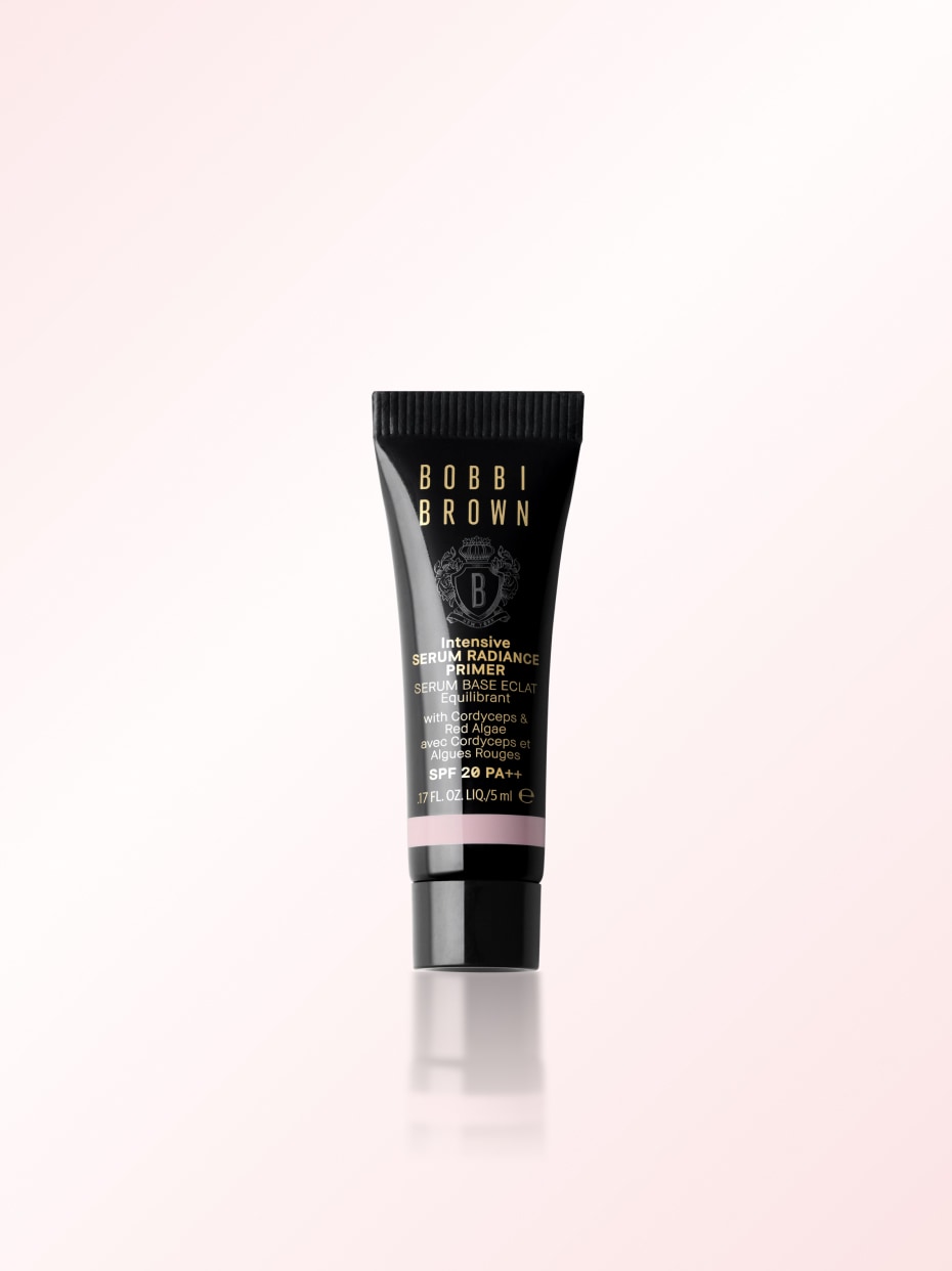 Model applying Skin Long-Wear Weightless Foundation to skin with a foundation brush